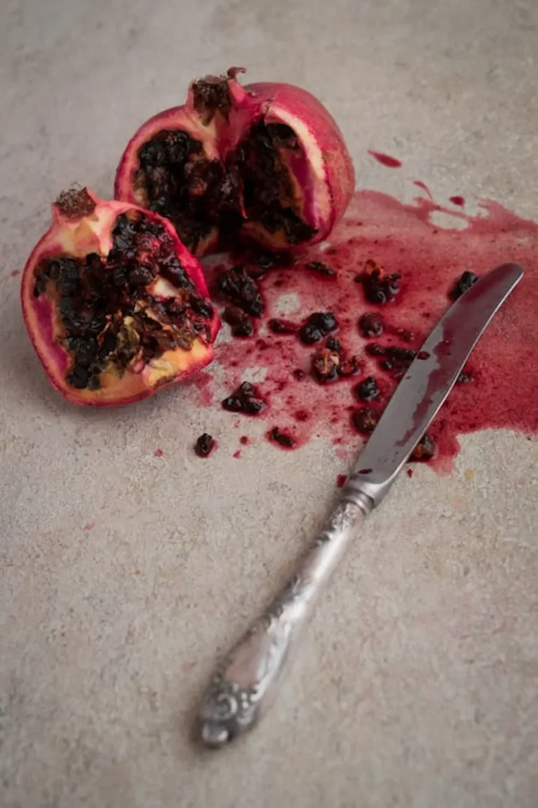 Un cuchillo cortando una fruta de granada